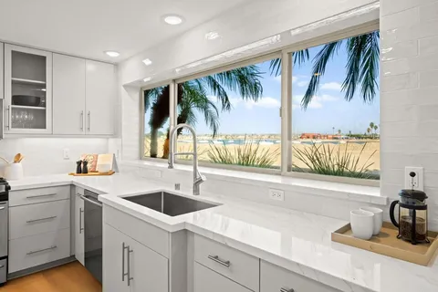 a kitchen with a sink and large window