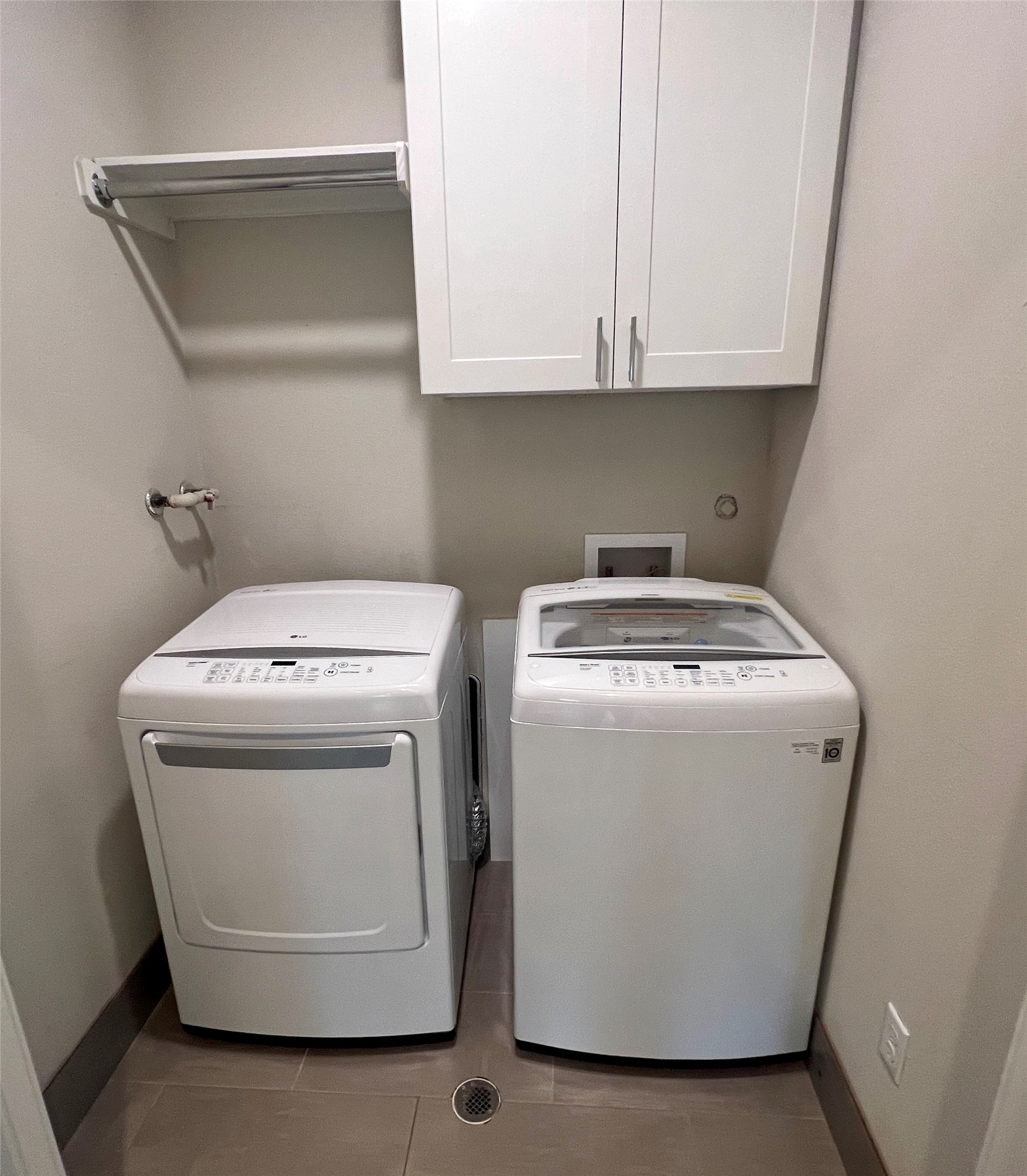 6515 Davis Lane, Unit 10 Austin, TX 78749 - Photo 22 of 22 Streamlined laundry area with convenient overhead cabinetry and sleek tile flooring.