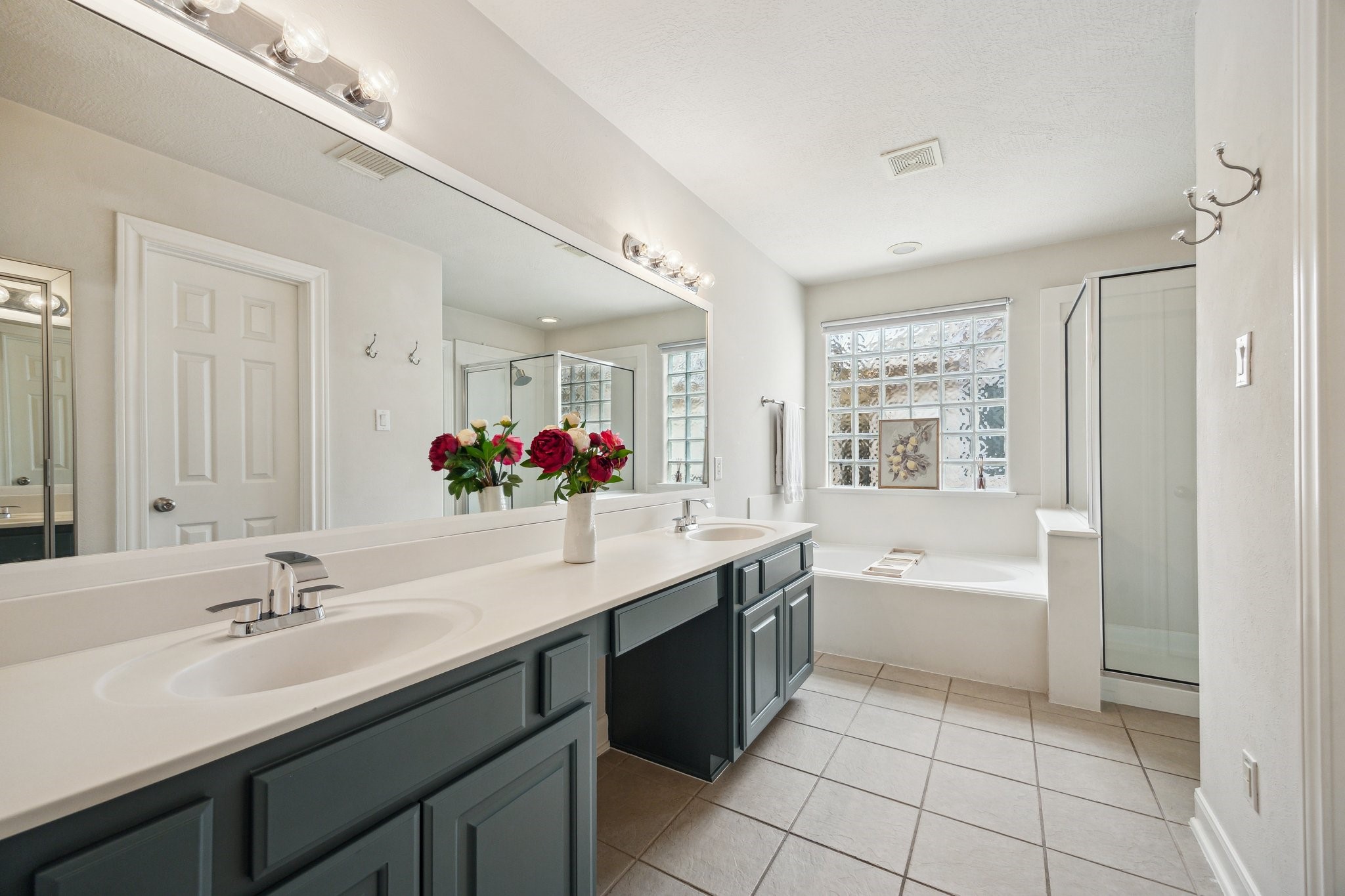 1310 Cohn Street Houston, TX 77007 - Photo 22 of 25 The newly updated primary bath includes double vanities, a soaking tub, separate shower, and a private water closet.