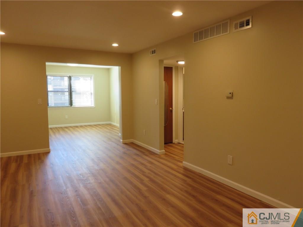 1927 Raspberry Court, Unit 1927 Edison, NJ 08817 - Photo 3 of 12 wooden floor in an empty room with a window