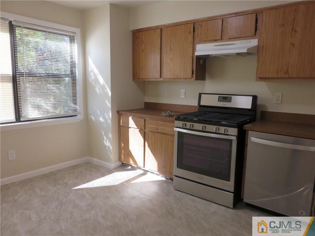 1927 Raspberry Court, Unit 1927 Edison, NJ 08817 - Photo 8 of 12 a kitchen with granite countertop a stove a sink and a cabinets