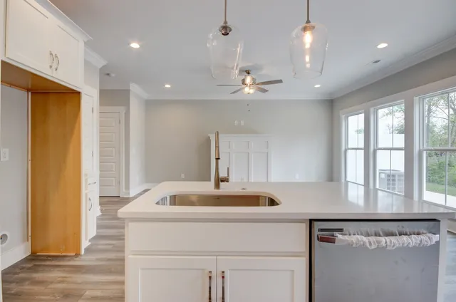 a kitchen with a sink appliances and cabinets