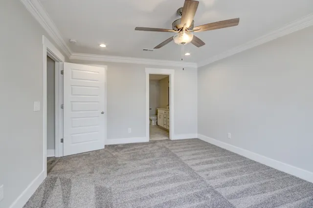 wooden floor in an empty room with a ceiling fan