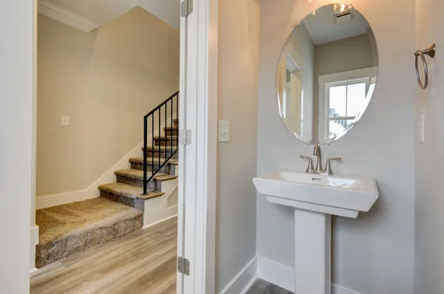 a view of a hallway with wooden floor and entryway