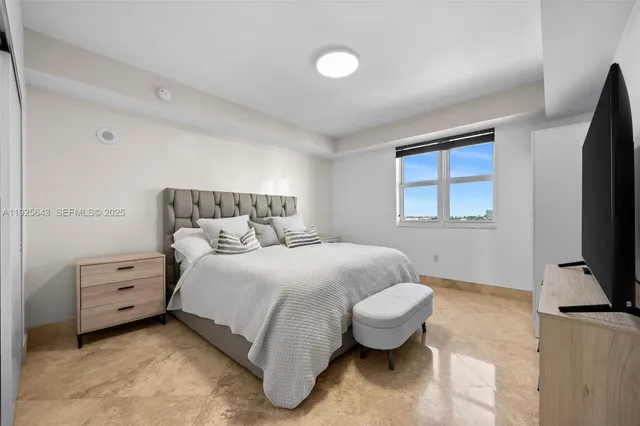 a bedroom with a bed and a flat screen tv