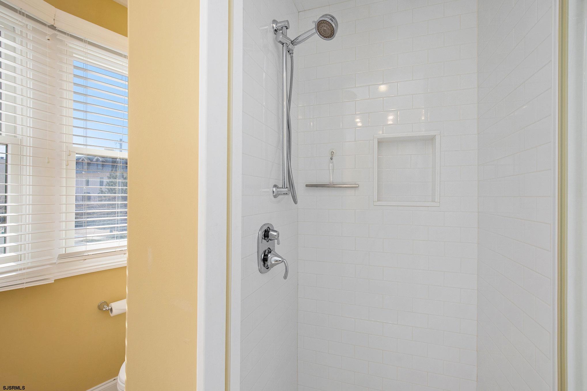 7611 Ventnor Avenue, Unit JUNE 2026 Margate City, NJ 08402 - Photo 28 of 49 a bathroom with a shower