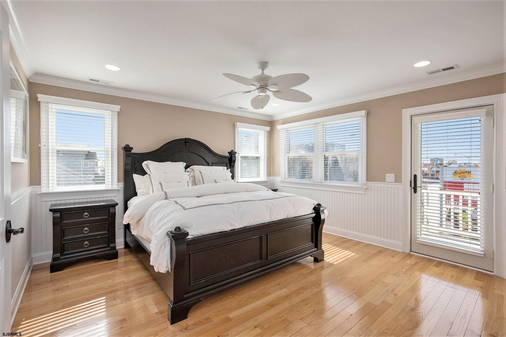 7611 Ventnor Avenue, Unit JUNE 2026 Margate City, NJ 08402 - Photo 29 of 49 a bedroom with a bed and window