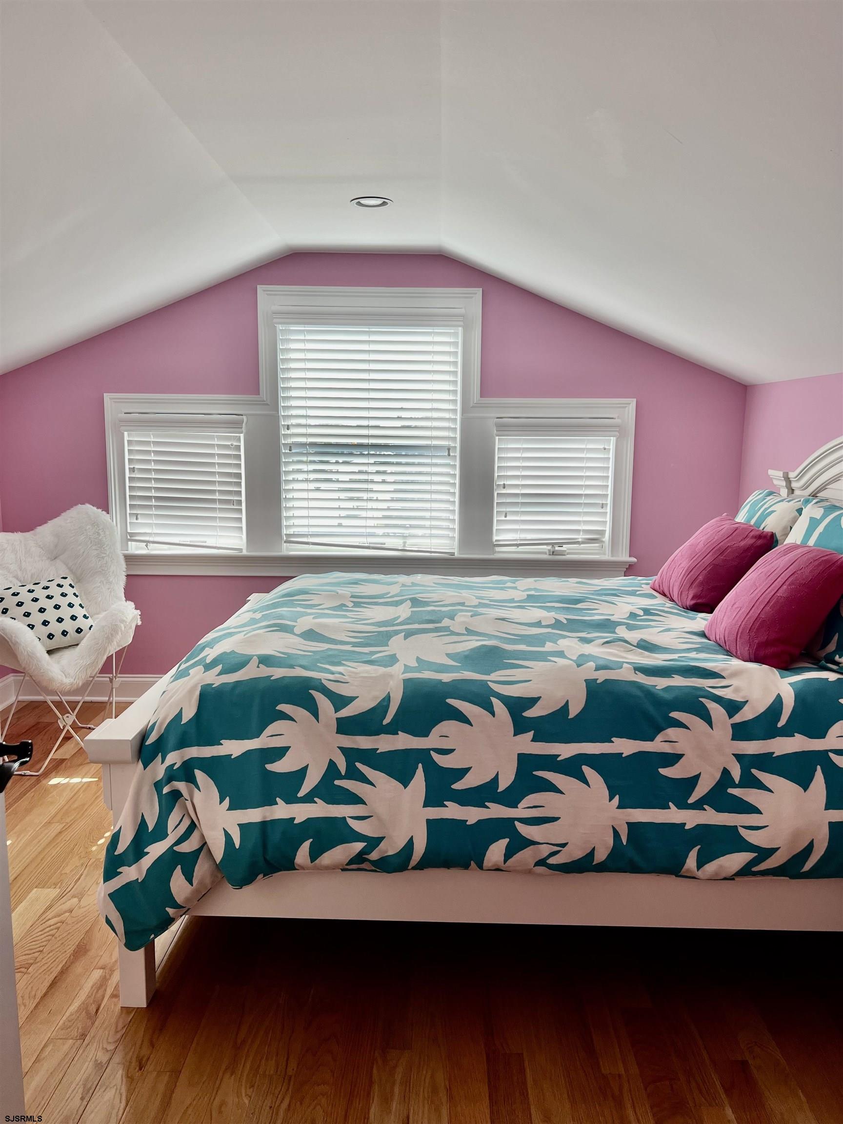 7611 Ventnor Avenue, Unit JUNE 2026 Margate City, NJ 08402 - Photo 45 of 49 a bedroom with a bed and a painting on the wall