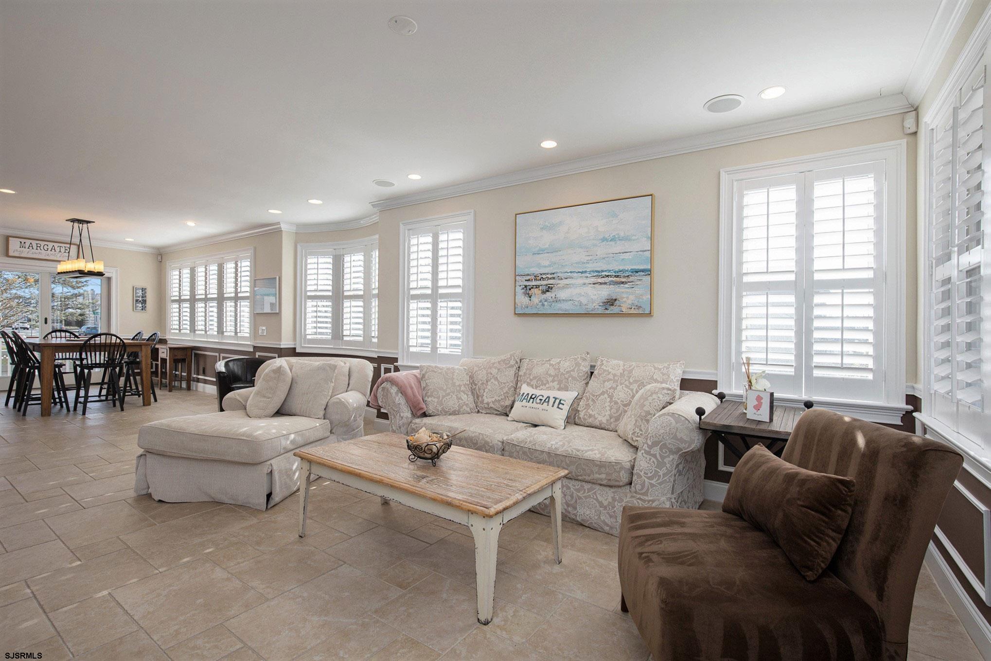 7611 Ventnor Avenue, Unit JUNE 2026 Margate City, NJ 08402 - Photo 7 of 49 a living room with furniture and a large window