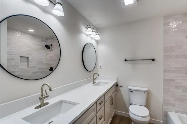 a bathroom with a toilet a sink and mirror