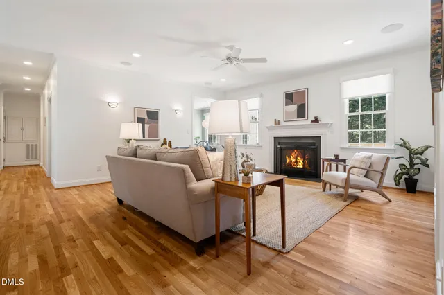 a living room with furniture a flat screen tv and kitchen view