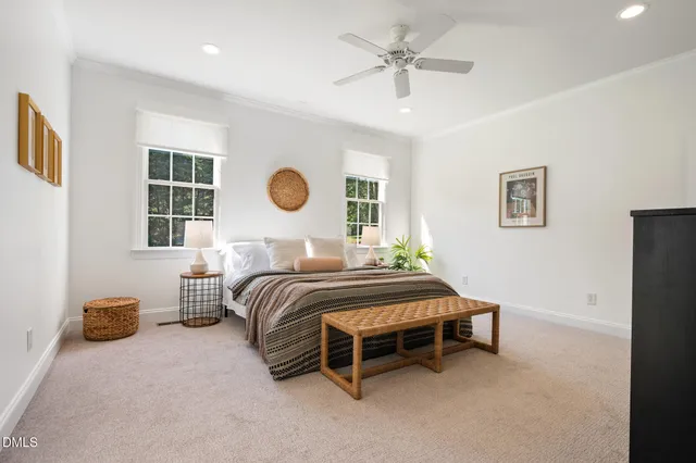 a bathroom with double vanity white cabinets and two mirror