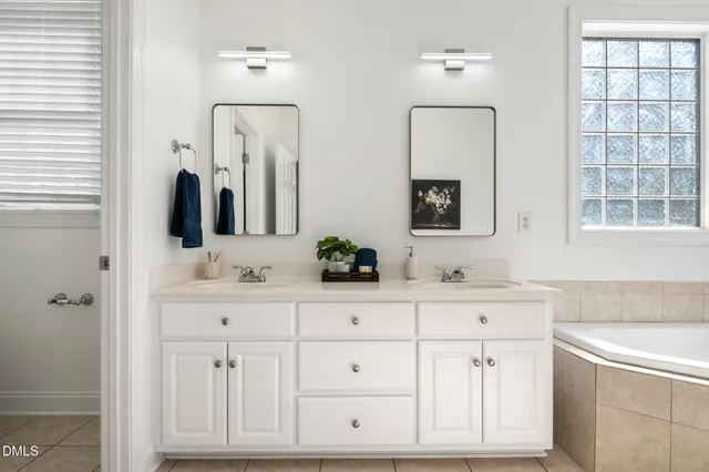 a spacious bathroom with a double vanity sink mirror and