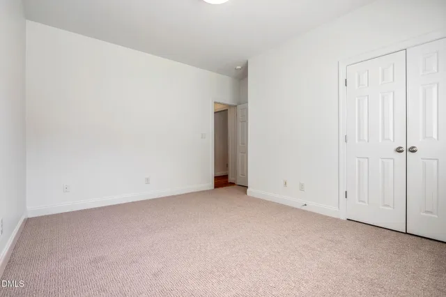 a spacious bedroom with a bed and a couch