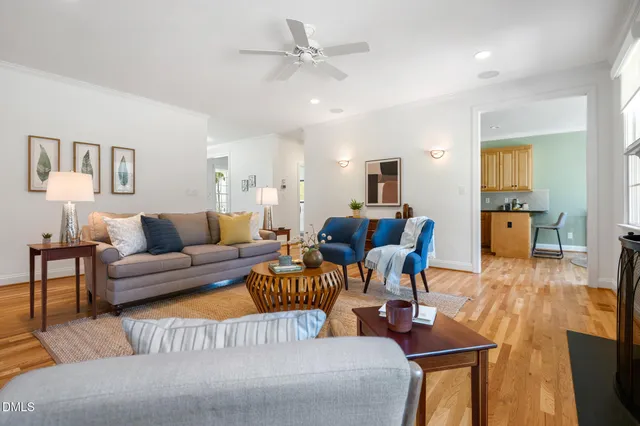 a living room with furniture large window and a fireplace