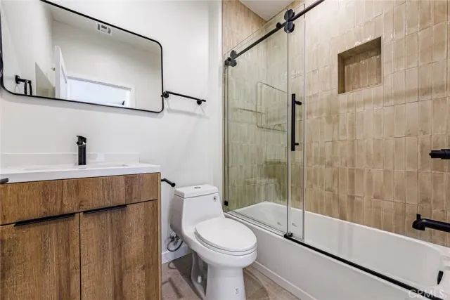 a bathroom with a toilet a sink and bathtub