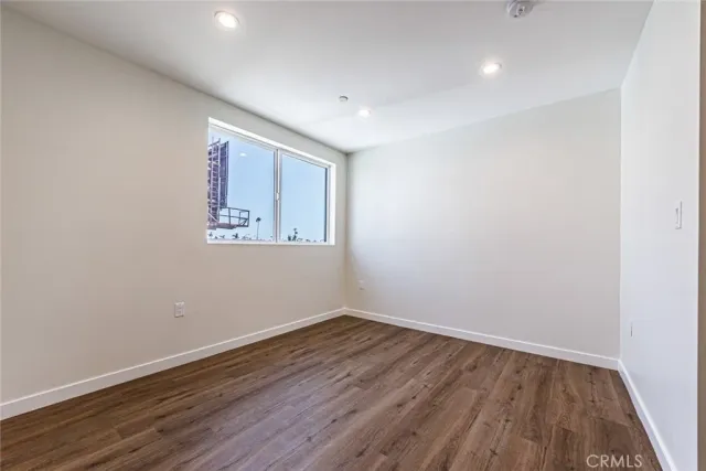 a view of room with wooden floor and window