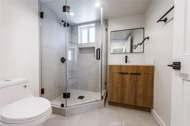 a bathroom with a shower a toilet and a shower