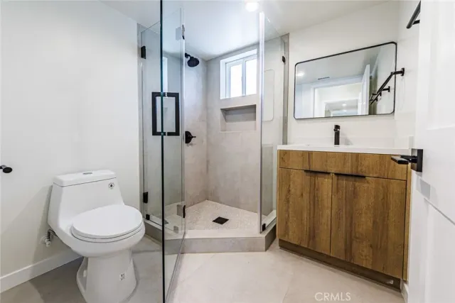a bathroom with a toilet sink and shower