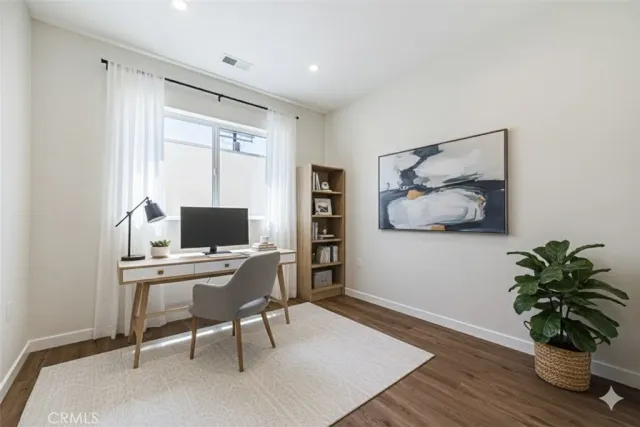 a workspace with furniture and a potted plant