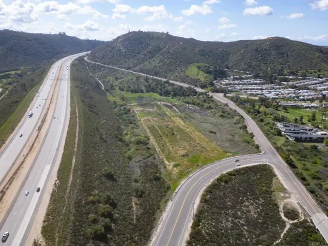 a view of a yard with wooden fence