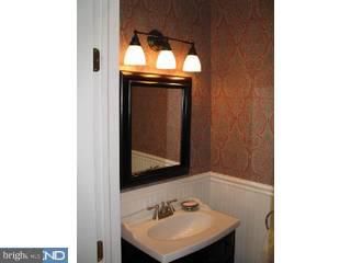 283 West Valley Road Wayne, PA 19087 - Photo 4 of 6 a bathroom with a sink and a mirror