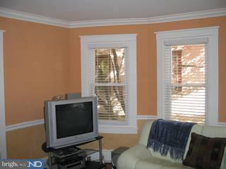 283 West Valley Road Wayne, PA 19087 - Photo 6 of 6 a living room with furniture a flat screen tv and a window