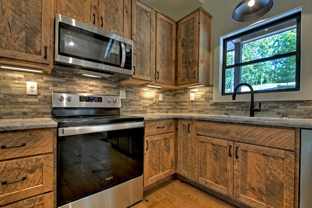 187 Chickadee Road Morganton, GA 30560 - Photo 24 of 94 a kitchen with stainless steel appliances granite countertop white cabinets granite counter tops and a window