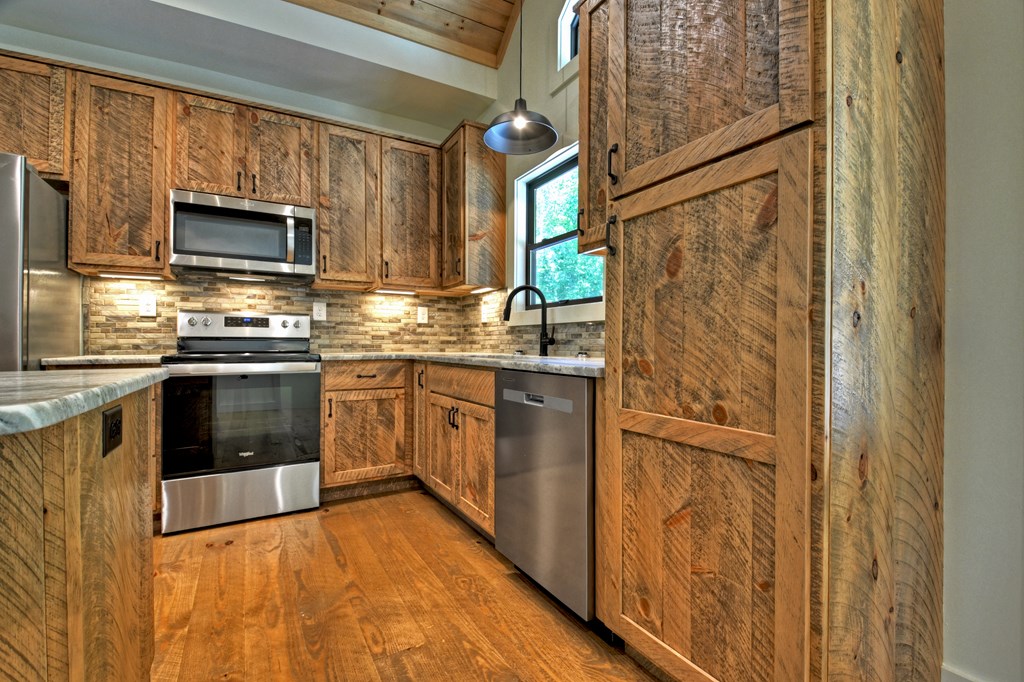 187 Chickadee Road Morganton, GA 30560 - Photo 25 of 94 a kitchen with stainless steel appliances granite countertop a stove a sink and a refrigerator