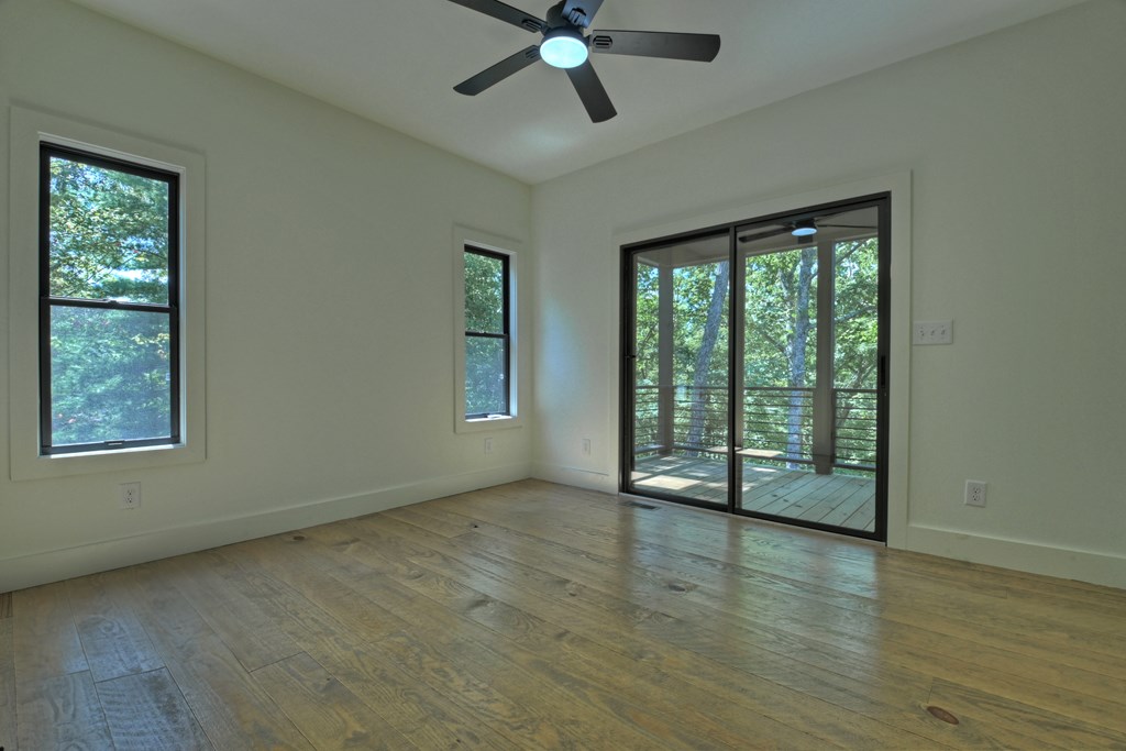 187 Chickadee Road Morganton, GA 30560 - Photo 28 of 94 a view of an empty room with wooden floor and a window