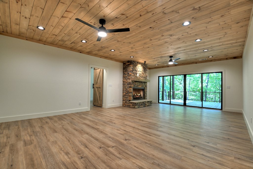 187 Chickadee Road Morganton, GA 30560 - Photo 36 of 94 an empty room with wooden floor and windows