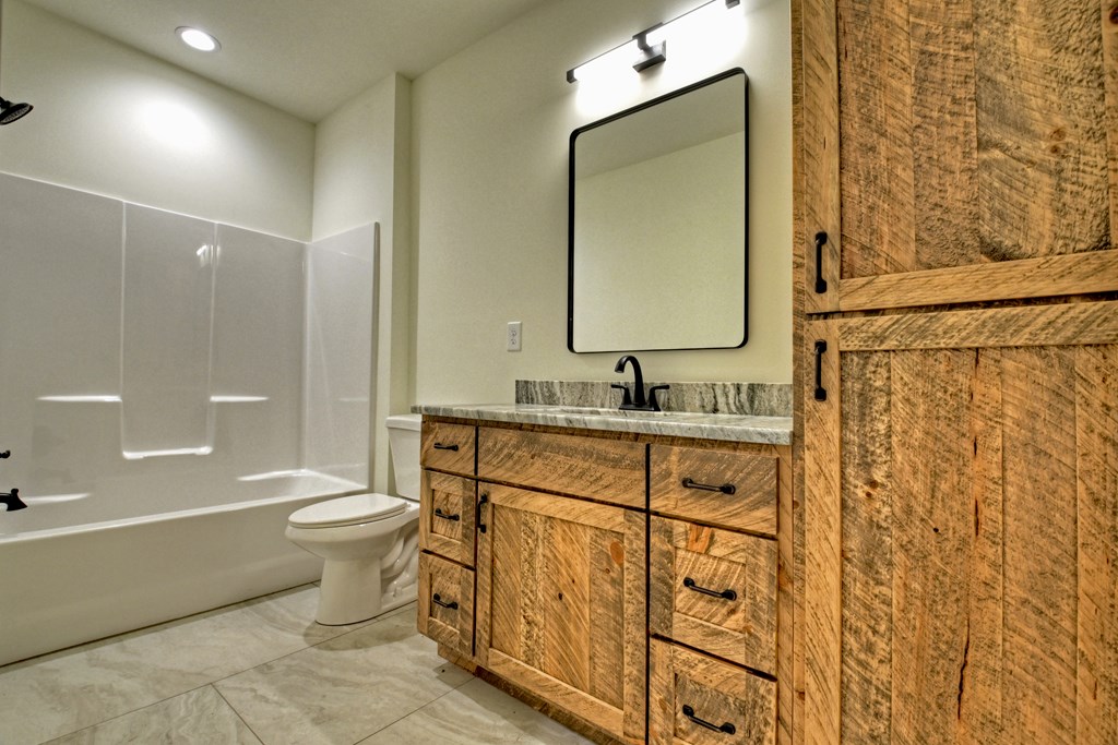 187 Chickadee Road Morganton, GA 30560 - Photo 40 of 94 a bathroom with a granite countertop sink toilet and shower