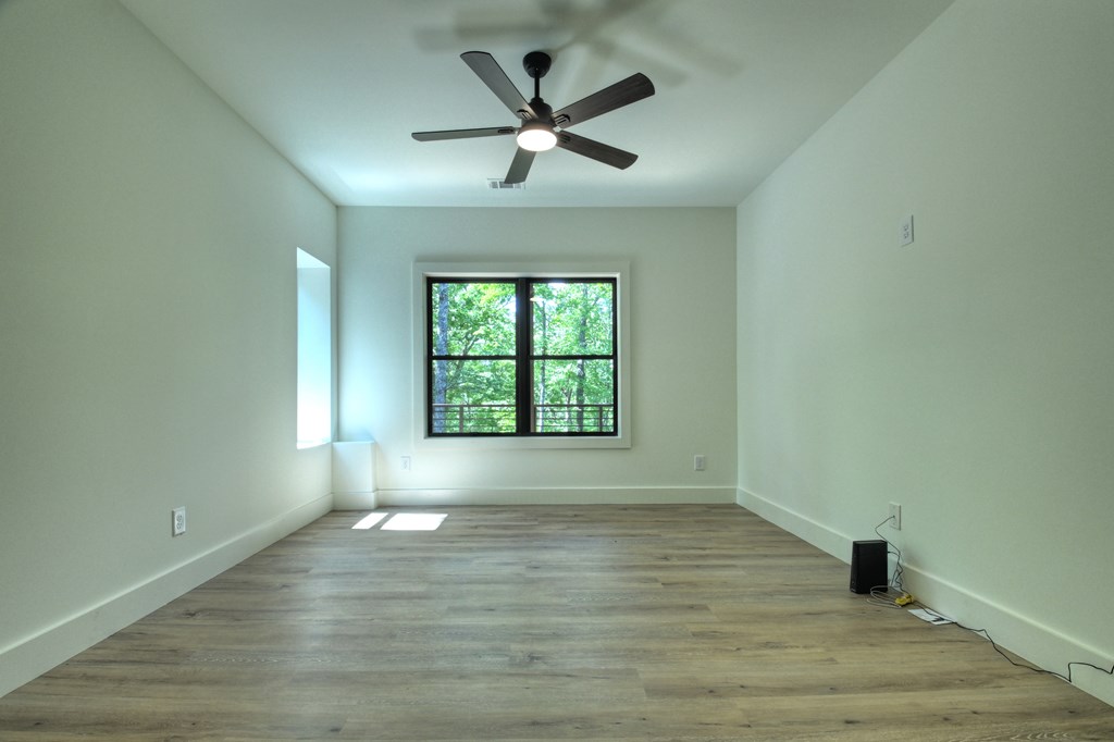 187 Chickadee Road Morganton, GA 30560 - Photo 41 of 94 an empty room with wooden floor and windows