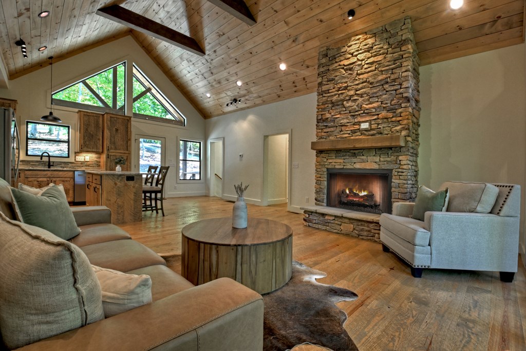 187 Chickadee Road Morganton, GA 30560 - Photo 66 of 94 a living room with furniture a fireplace and a large window