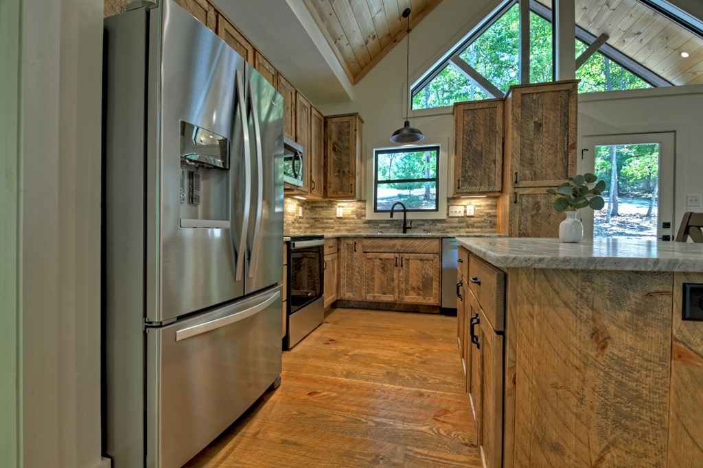 187 Chickadee Road Morganton, GA 30560 - Photo 69 of 94 a kitchen with stainless steel appliances granite countertop a refrigerator a sink a stove and a refrigerator