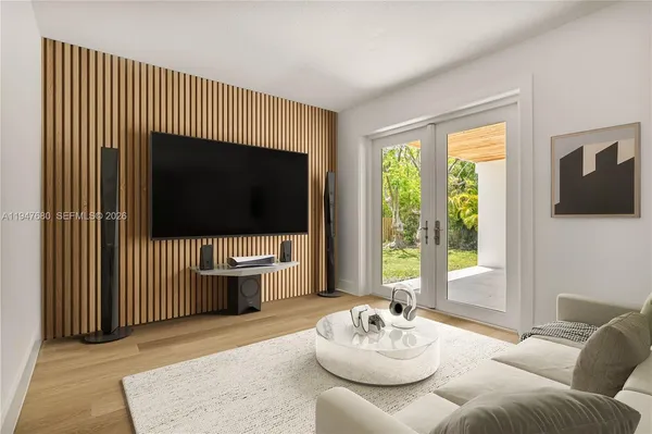 a living room with furniture and a flat screen tv