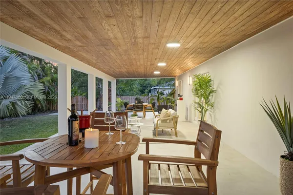 a view of an outdoor dining space with furniture and garden