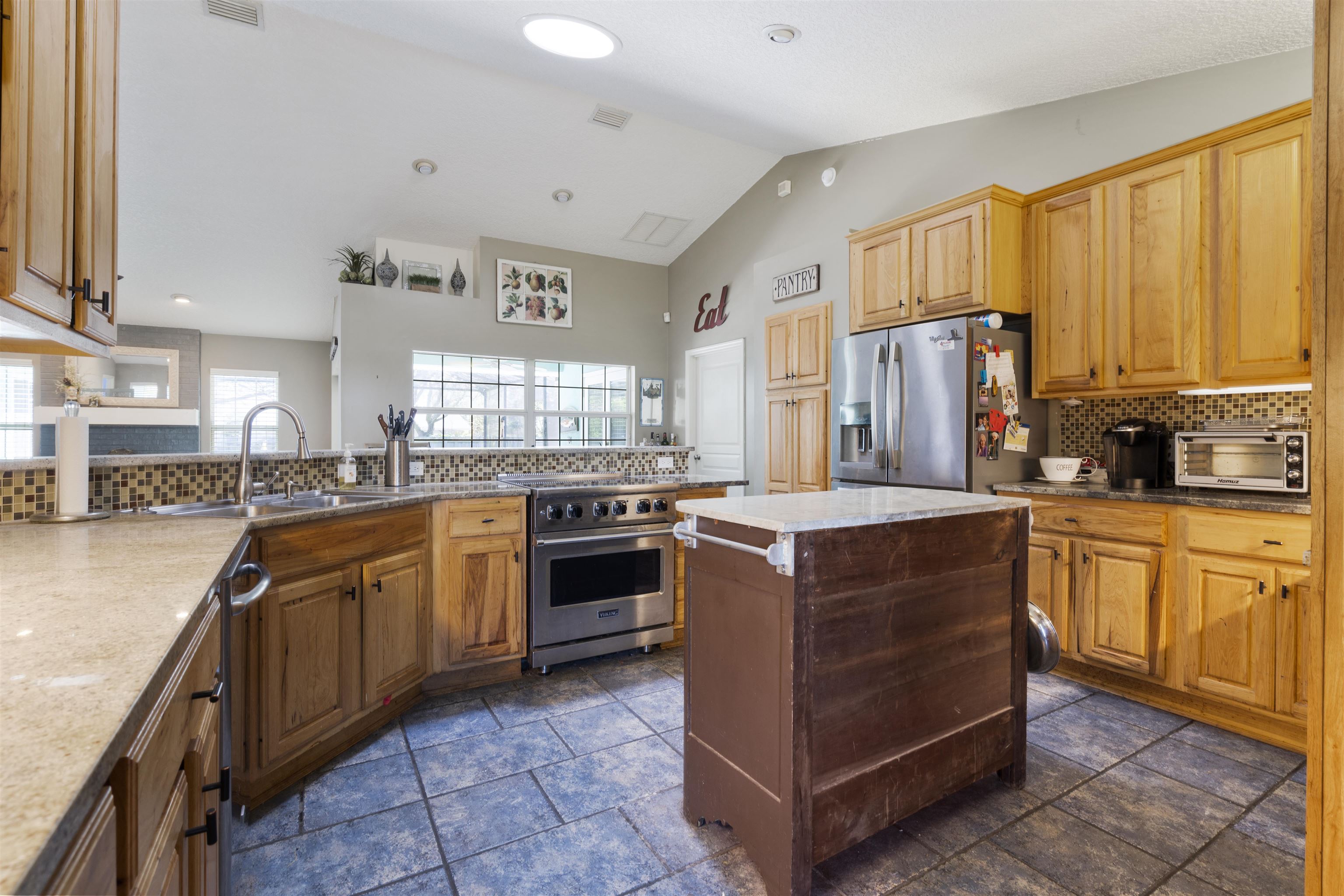 5372 5th Street St. Augustine, FL 32080 - Photo 14 of 46 a kitchen with stainless steel appliances granite countertop a stove a sink dishwasher and a refrigerator