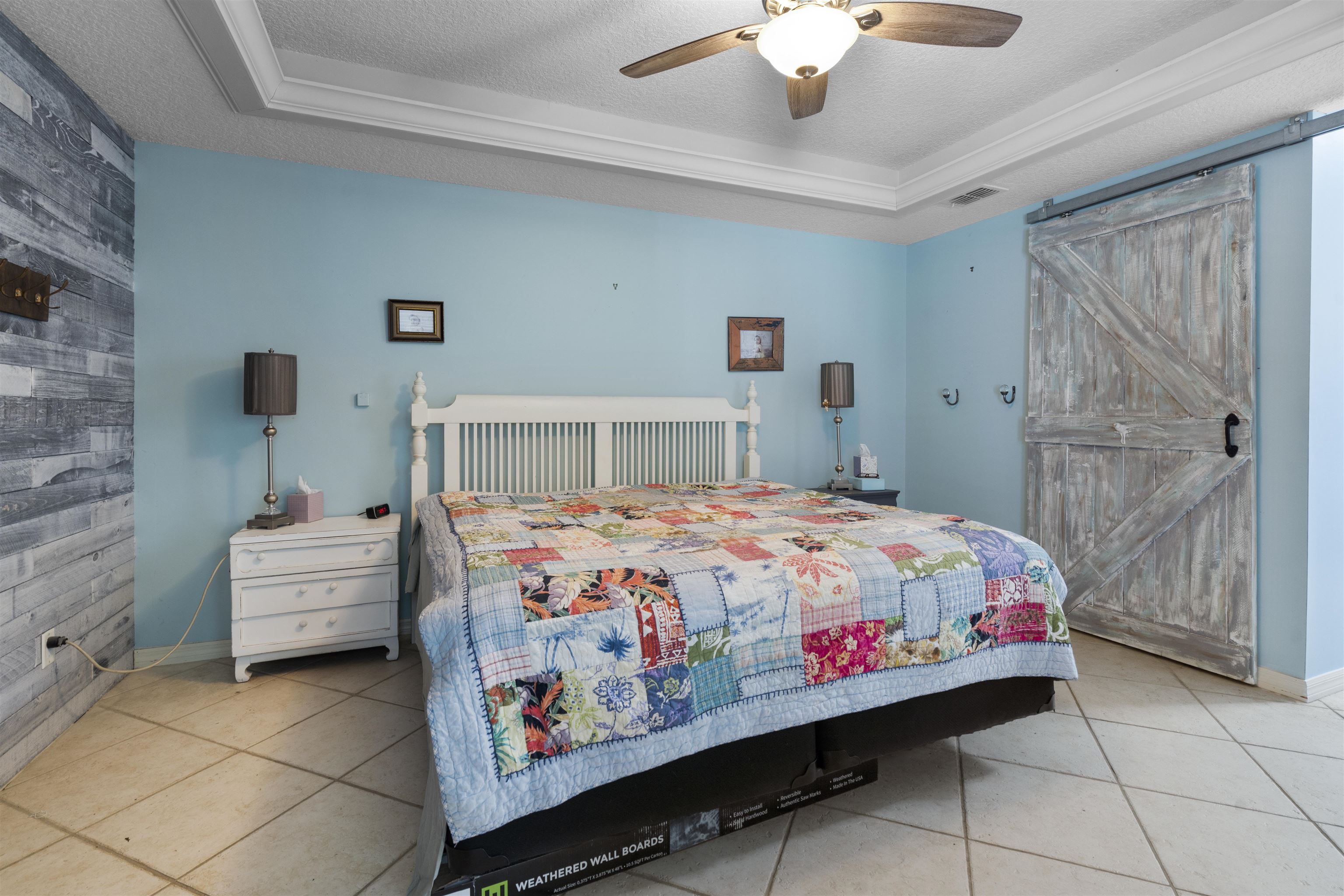5372 5th Street St. Augustine, FL 32080 - Photo 19 of 46 a bedroom with a bed and a chandelier