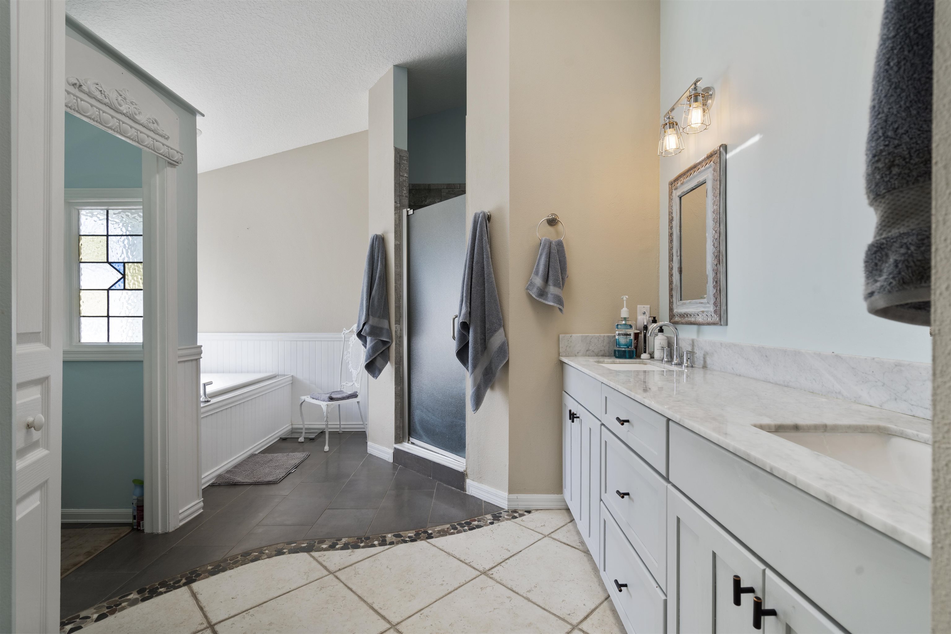 5372 5th Street St. Augustine, FL 32080 - Photo 21 of 46 a spacious bathroom with a granite countertop sink a toilet and a large mirror