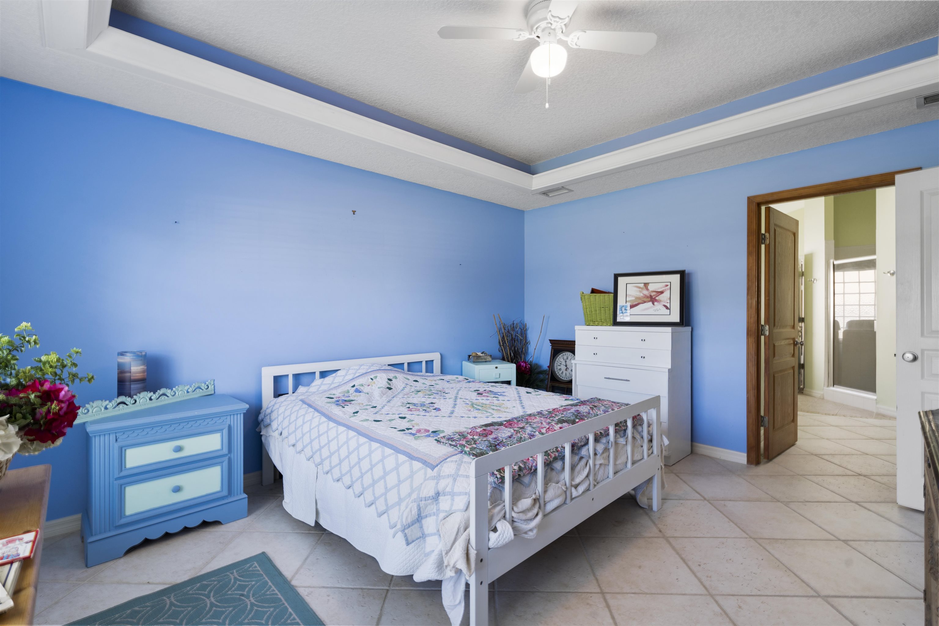 5372 5th Street St. Augustine, FL 32080 - Photo 24 of 46 a bedroom with a bed and a chandelier