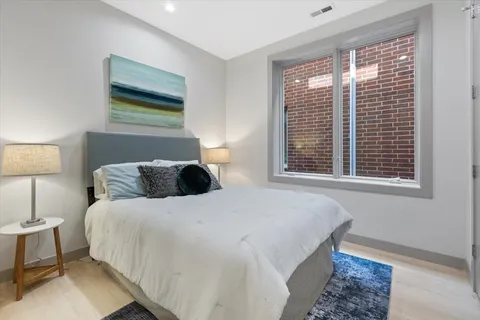 a bedroom with a bed and a window