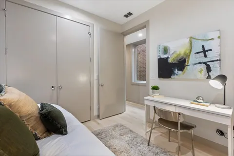 a bedroom with a bed and a potted plant