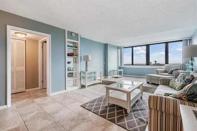 a living room with furniture a rug and a window