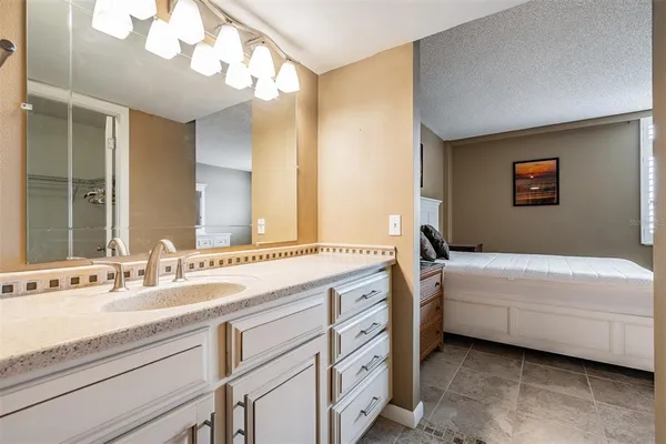 a bathroom with a double vanity sink mirror and bathtub