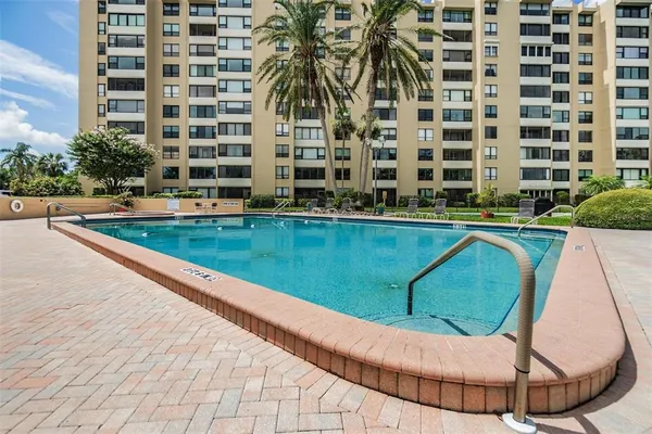 a view of a swimming pool with a yard