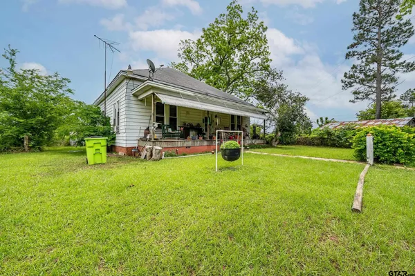 a view of a house with a backyard porch and sitting area