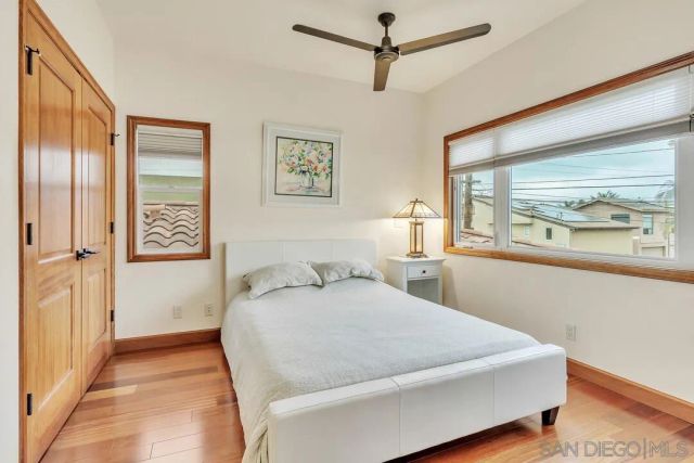 a bedroom with a large bed and a window