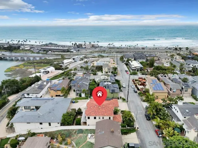 a dining room with stainless steel appliances a table and chairs