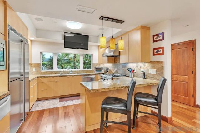 a dining room with furniture a window and wooden floor